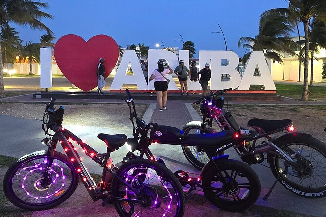 Semi-Private Christmas Edition Twilight Glow E-Bike Oranjestad - Plaza Turismo and the ARUBA sign: a quick local hangout pause
